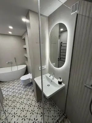 a bathroom with a sink and a tub and a mirror at Exclusive 2 Bedroom Apartment Trendy City Center, Large Terrace & Free Parking in Vilnius