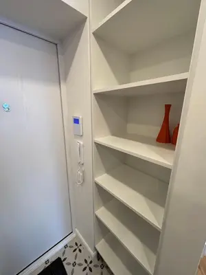 a white walk in closet with white shelves at Exclusive 2 Bedroom Apartment Trendy City Center, Large Terrace & Free Parking in Vilnius