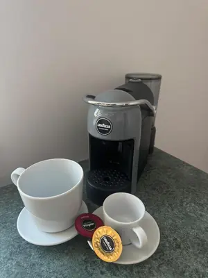 a coffee maker with two cups on a counter at Urban Nest Čiurlionio Apartment City Center in Druskininkai