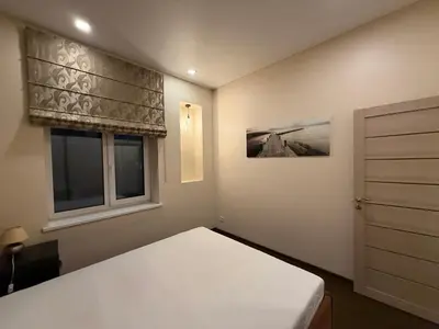 a bedroom with a bed and a window at Kęstučio 66 apartamentai in Kaunas