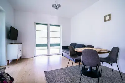a living room with a table and chairs and a couch at River apartamentai in Pakopi