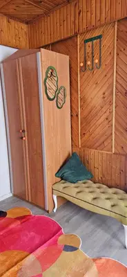 a room with a bed in a wooden room at Skodupės švenčių ir poilsio namai in Pakopi