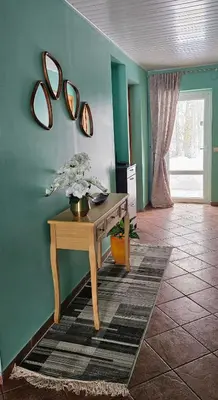 a room with a table and mirrors on the wall at Skodupės švenčių ir poilsio namai in Pakopi