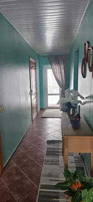 a room with blue walls and a table and a door at Skodupės švenčių ir poilsio namai in Pakopi
