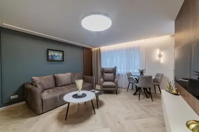 a living room with a couch and a table at Sandal Apartments in Šiauliai