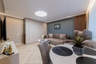a living room with a couch and a table at Sandal Apartments in Šiauliai