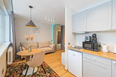a kitchen and living room with a table and a couch at Fancy Pramonės Stay #1 By Polo Apartments in Kaunas
