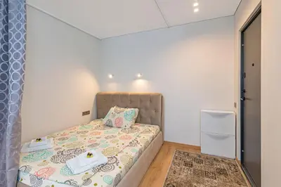 a small bedroom with a bed with towels on it at Fancy Pramonės Stay #1 By Polo Apartments in Kaunas