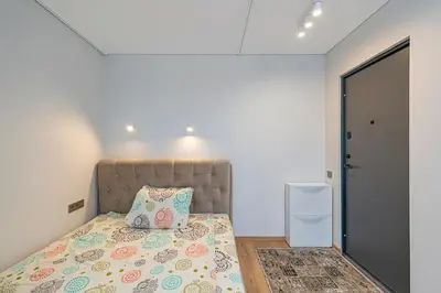 a bedroom with a bed and a small refrigerator at Fancy Pramonės Stay #1 By Polo Apartments in Kaunas