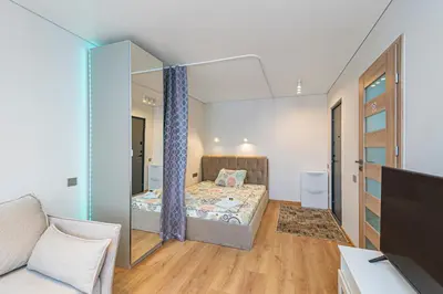 a bedroom with a bed and a mirror at Fancy Pramonės Stay #1 By Polo Apartments in Kaunas