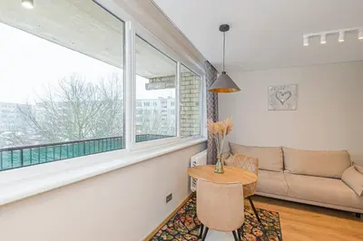 a living room with a couch and a table and a window at Fancy Pramonės Stay #1 By Polo Apartments in Kaunas
