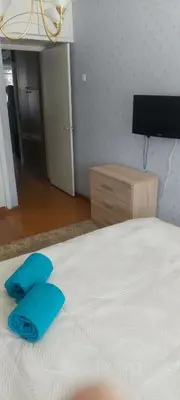 a bedroom with a bed with blue pillows on it at Flat 2 rooms in Panevėžys