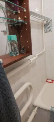 a bathroom with a sink and a shelf and a toilet at Flat 2 rooms in Panevėžys