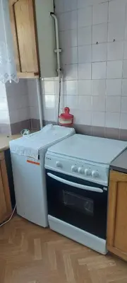 a kitchen with a stove and a counter top at Flat 2 rooms in Panevėžys