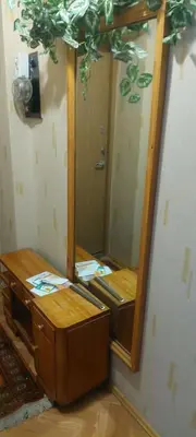 a bathroom with a mirror and a wooden dresser at Flat 2 rooms in Panevėžys