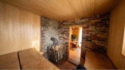 a room with a brick wall and a fireplace at Sudervės pirtelė poilsiui gamtoje, Vilnius už 12 km in Sudervė