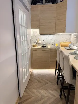 a kitchen with a table and chairs and a counter at Cosy quiet apartment in the city center in Vilnius