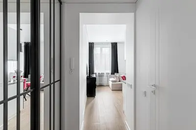 a hallway with white walls and a living room at Vilnius Studio Apartment with Free Parking and Self Check In in Vilnius