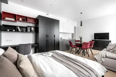 a bedroom with a bed and a table and chairs at Vilnius Studio Apartment with Free Parking and Self Check In in Vilnius