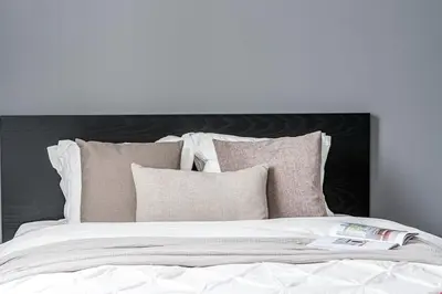 a white bed with pillows and a book on it at Vilnius Studio Apartment with Free Parking and Self Check In in Vilnius
