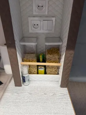 a toy kitchen with a shelf and some food at PaRina in Vilnius