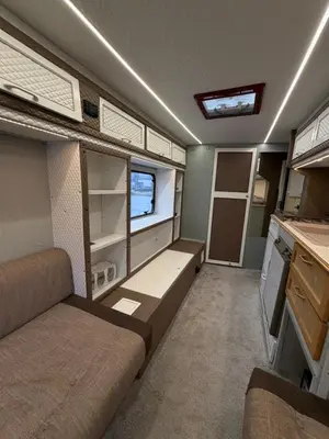 an interior of an rv with a bed and a kitchen at PaRina in Vilnius