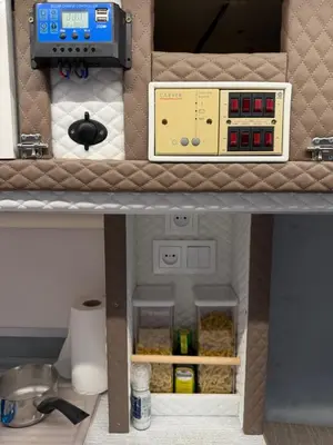 a model of a kitchen with a box on a shelf at PaRina in Vilnius
