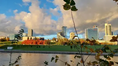 a view of a city with a river and buildings at Vilnius Gate Skyline Studio in Vilnius
