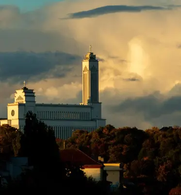 a large white building with a clock tower on top at Plytų Sienos Apartamentai in Kaunas