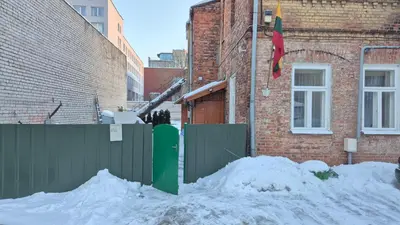 a pile of snow in front of a building at Plytų Sienos Apartamentai in Kaunas