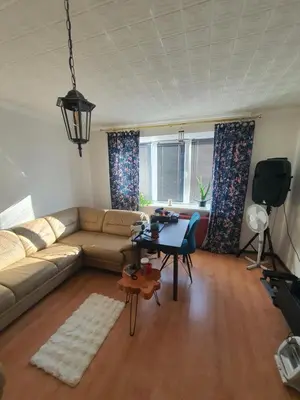 a living room with a couch and a table at Horses Forests Lakes Shops in Visaginas