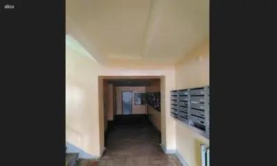 an empty hallway in a building with a hallwaygue at Horses Forests Lakes Shops in Visaginas
