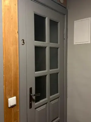 a door with three windows in a room at Užupio apartamentai Nemokamas parkingas 3 in Vilnius