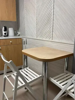 a small table and a chair in a kitchen at Užupio apartamentai Nemokamas parkingas 3 in Vilnius