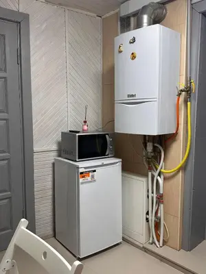 a small kitchen with a refrigerator and a microwave at Užupio apartamentai Nemokamas parkingas 3 in Vilnius