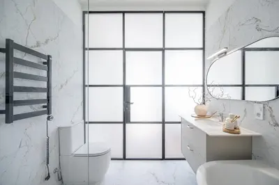 a bathroom with a toilet and a sink and a window at Sunny Garden Street Apartment in Vilnius in Vilnius