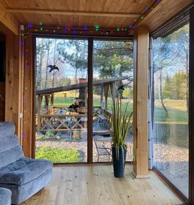 a living room with a large sliding glass door at Gintarinė rasa in Inkartai