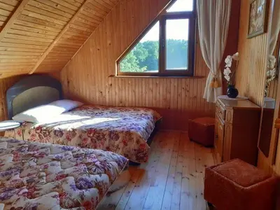 a bedroom with two beds and a window at Gintarinė rasa in Inkartai