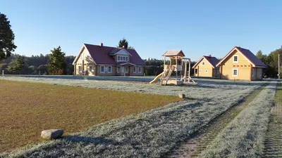 a house with a playground in front of a house at Panemunio sodyba in Birštonas