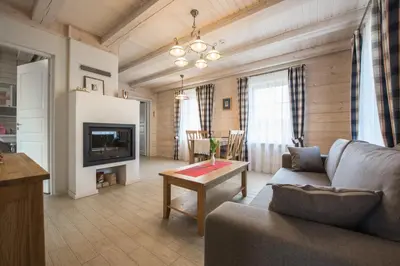 a living room with a couch and a table at Panemunio sodyba in Birštonas