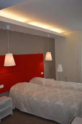 a bedroom with two beds and two lights at Mokomasis svetingumo centras in Utena