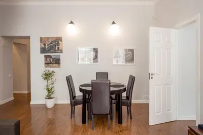 a dining room with a table and chairs at Maironis Apartment in Kaunas