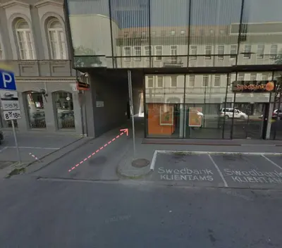 an empty street in front of a building at Maironis Apartment in Kaunas