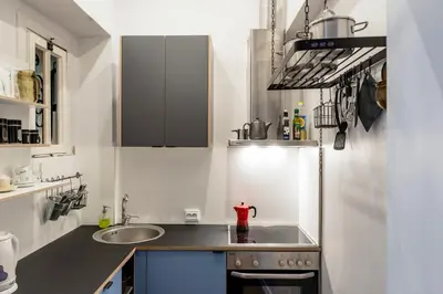 a small kitchen with a sink and a counter at Maironis Apartment in Kaunas