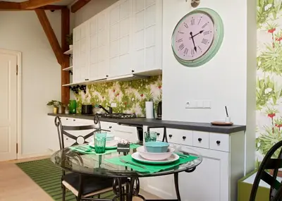 a kitchen with a table and a clock on the wall at Town Hall Apartments FREE Parking in Vilnius