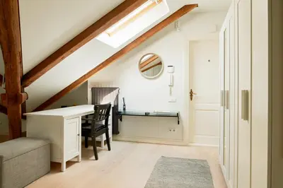 an attic office with a desk and a chair at Town Hall Apartments FREE Parking in Vilnius