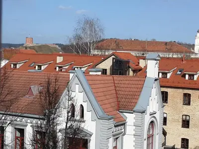 a group of buildings with red roofs at Town Hall Apartments FREE Parking in Vilnius