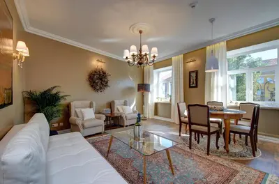 a living room with a white couch and a table at German18-3A Luxury Vilnius apartment in Vilnius