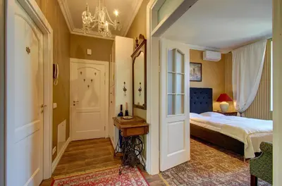 a bedroom with a bed and a chandelier at German18-3A Luxury Vilnius apartment in Vilnius