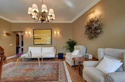 a living room with white furniture and a chandelier at German18-3A Luxury Vilnius apartment in Vilnius